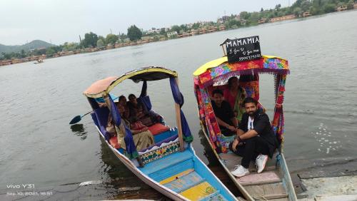 a group of people riding on a boat on the water at Houseboats Jackson Heights in Srinagar