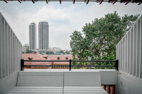 a view of the city from the balcony of a building at Happio - SHA Plus Certified in Bangkok