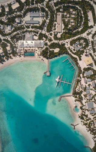 an aerial view of a resort on a beach at Patina Maldives, Fari Islands in North Male Atoll
