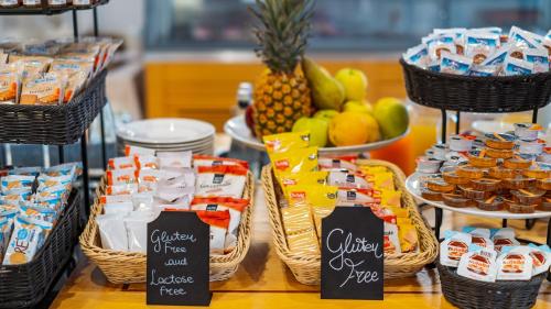 a table with baskets of food and fruit on display at Prealpi Hotel in San Vendemiano