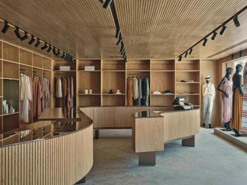 a dressing room with wooden walls and shelves of clothes at Patina Maldives, Fari Islands in North Male Atoll