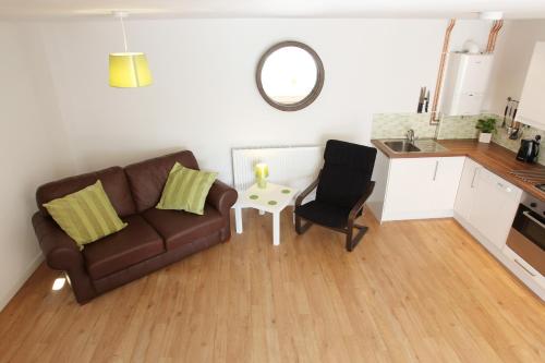 a living room with a couch and a table at Elm Tree Farm Accommodation in Milton Keynes