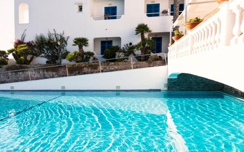 a swimming pool in front of a building at Hotel Grazia alla Scannella in Ischia