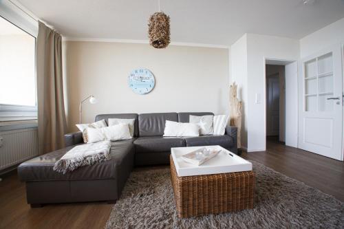 a living room with a couch and a table at Haus Uthlande Uthlande Whg 49 Inselauszeit in Wyk auf Föhr