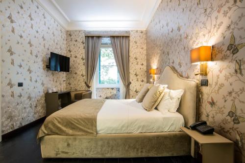 Voodi või voodid majutusasutuse Via Veneto Suites toas