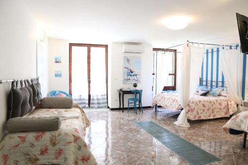 a bedroom with two beds and a desk in it at Albergo Del Centro Storico in Salerno