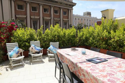 a table and chairs on a rooftop patio at Albergo Del Centro Storico in Salerno