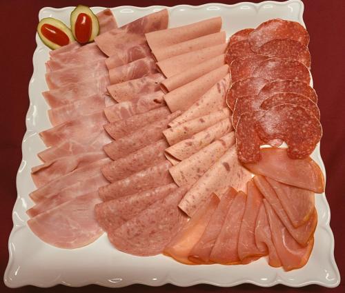 a plate of food with meats and bread on it at Hotel am Freihafen in Duisburg