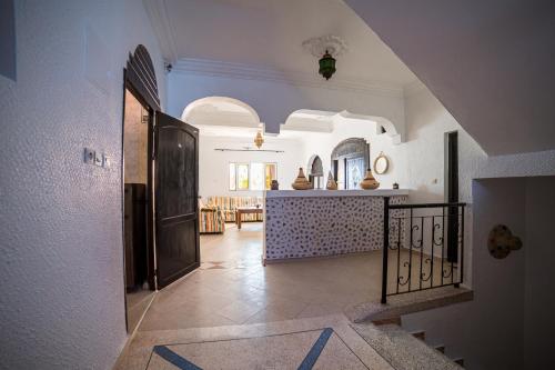 a hallway of a house with a hallway leading to a kitchen at Original Surf Morocco in Tamraght Ouzdar