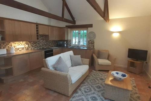 a living room with a couch and a table at Ardevora Mill in Truro