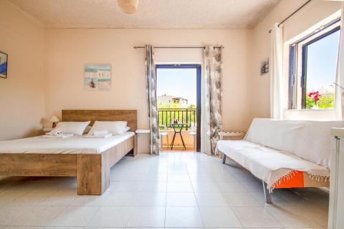 a bedroom with two beds and a couch at Andy's Gardens in Gerani