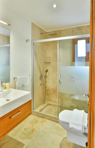 a bathroom with a shower and a toilet and a sink at Çınarlar Apart Hotel KAŞ in Kas