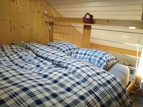 a couple of beds sitting in a room at "Les Echalas" Chalet indépendant avec cuisine en Lavaux Unesco in Chexbres
