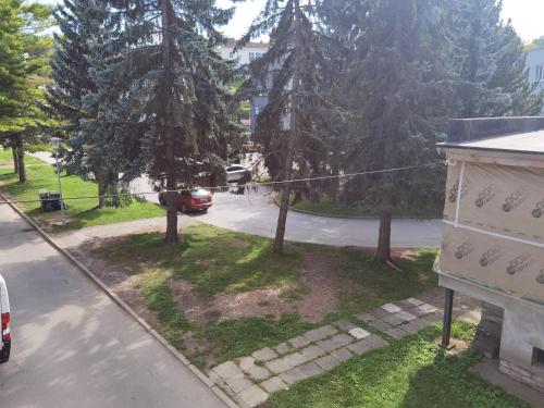 an aerial view of a street with trees and a car at Apartmán RUŽA in Ružomberok