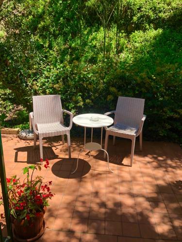 two chairs and a table on a patio at Villa Emma Malcesine in Malcesine
