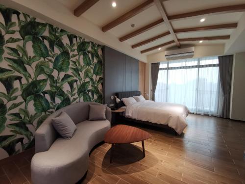 a bedroom with a bed and a couch and a bed at Meets Anping in Tainan