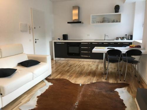 a living room with a white couch and a table at Casa Marchiodi in Trento