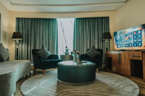 a living room with a couch and a table at Grand Millennium Sulaimani in As Sulaymānīyah