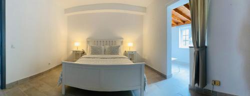 une chambre avec un lit blanc dans une pièce dans l'établissement LC Bastian Marina Bungalow, à Costa Teguise