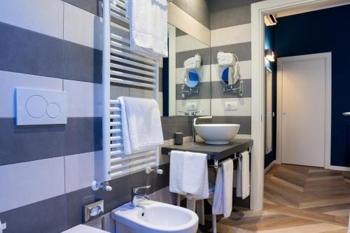 a bathroom with a sink and a toilet at Hotel Monte Rosa in Chiavari