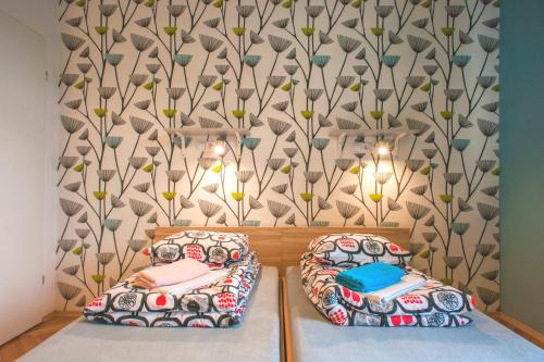 two beds in a room with a wall at Atlantis Hostel in Kraków