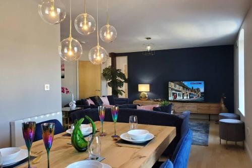 a living room with a wooden table with wine glasses at The Riverside at Woodsmill Quay with parking in York