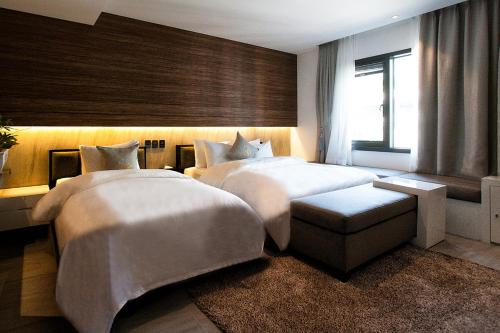 a hotel room with two beds and a window at Golden Hotel Incheon in Incheon