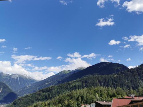 a view of a mountain range with trees and buildings at Apart Sport-Stock in Finkenberg