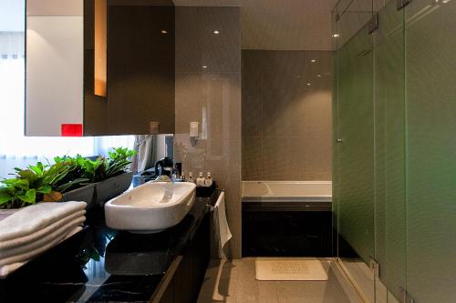 a bathroom with a sink and a glass shower at Golden Hotel Incheon in Incheon