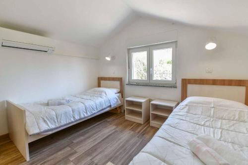 a bedroom with two beds and a window at Studio in Stara Baska/Insel Krk 34427 in Stara Baška