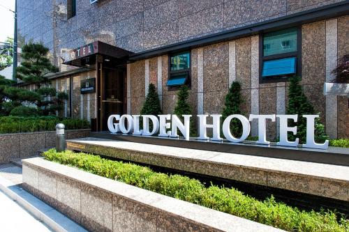 a hotel sign on the side of a building at Golden Hotel Incheon in Incheon
