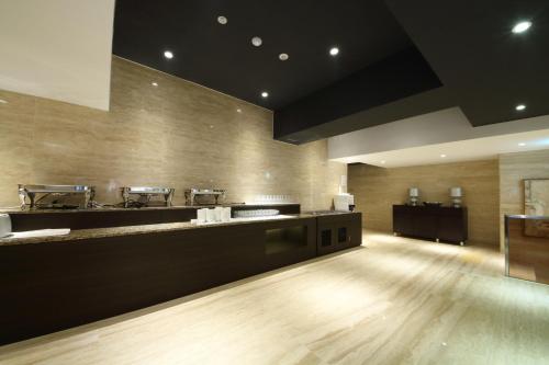 a large kitchen with wooden floors and a counter at Golden Hotel Incheon in Incheon