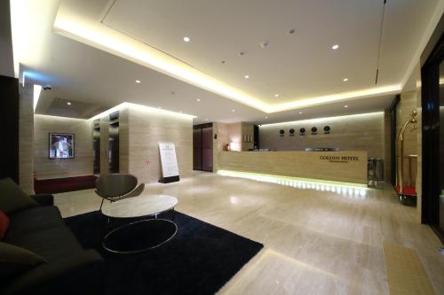 a lobby with a couch and a table at Golden Hotel Incheon in Incheon