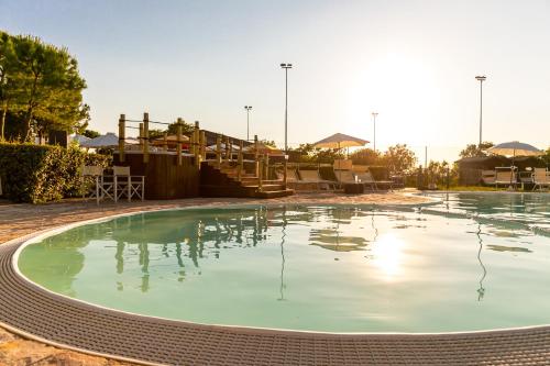 a large pool of green water in a yard at Il Podere Del Germano Reale in Coriano