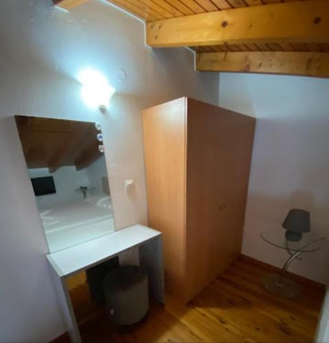 a room with a desk and a light on a wall at Apartments Barbie in Rethymno Town