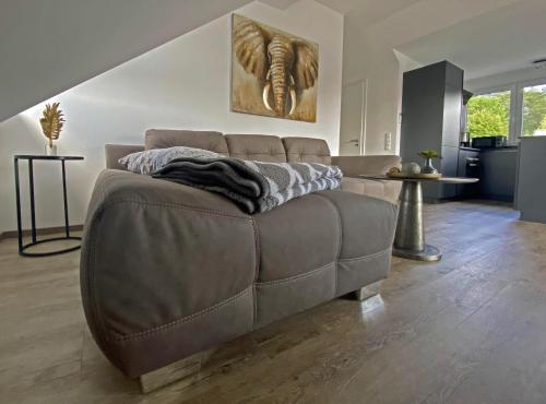 una sala de estar con un sofá marrón en una habitación en Babenberg, en Bamberg