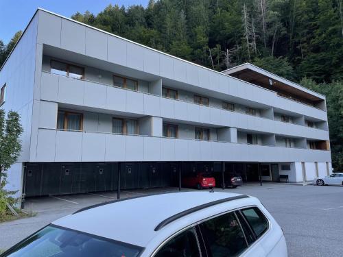 a white car parked in front of a building at Ferienwohnung Herold in Bartholomäberg