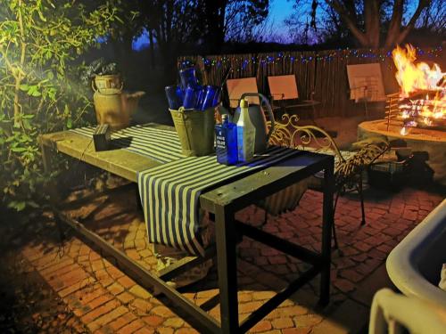a picnic table with a green and white striped table cloth at Soutpan Guesthouse in Soutpan