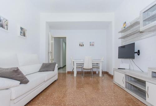 a living room with a white couch and a table at Apartamento San Pascual en Orihuela in Orihuela