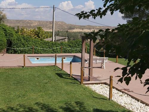 a swimming pool in the yard of a house at Casa rural tres regiones in Ontiñena