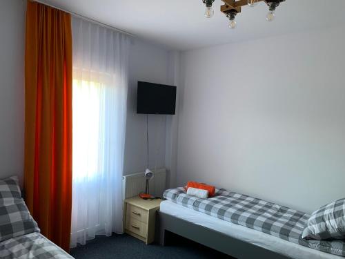 Ένα ή περισσότερα κρεβάτια σε δωμάτιο στο Willa Świetlana