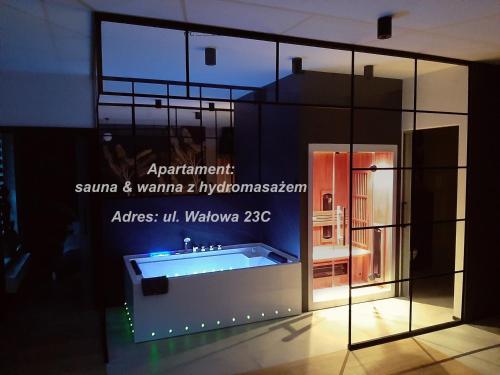 a display case with a tub in a room at Jacuzzi Apartamenty Gdańsk - RELAX Apartments in Gdańsk
