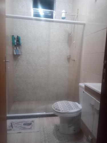 a small bathroom with a shower and a toilet at Nosso Pedacinho in Abraão