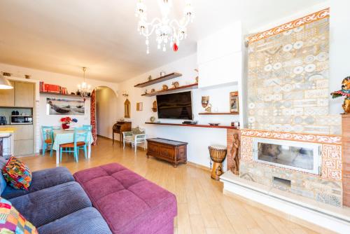 a living room with a couch and a fireplace at Extravacanza Safari in Selva di Fasano