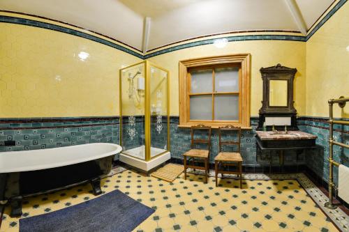 a bathroom with a tub and a sink at Pannett House Guesthouse in Whitby