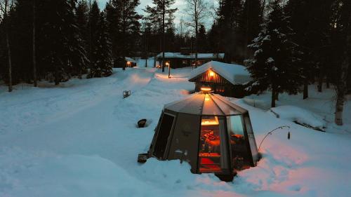 a gazebo with a light in the snow at Ollero Eco Lodge (including a glass igloo) in Rovaniemi