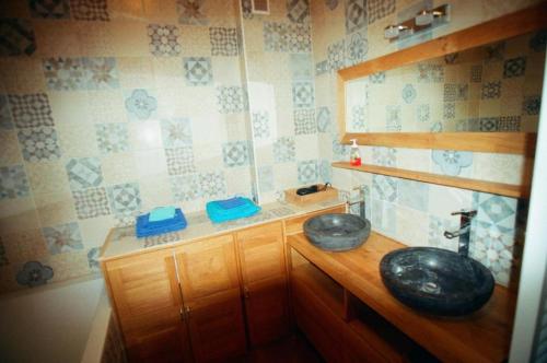 a bathroom with two sinks on a wooden counter at Chouette in Annecy