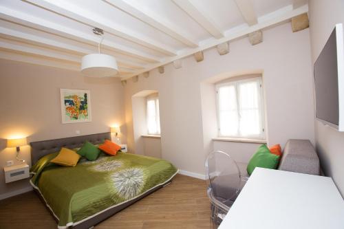 a bedroom with a green bed and a couch at Villa Flores Room in Dubrovnik