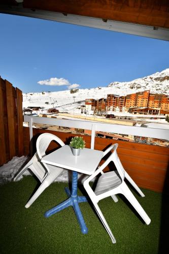 two chairs and a table on a balcony at Superb view+Swim Pool+Smart TV+Netflix+Projector in LʼHuez