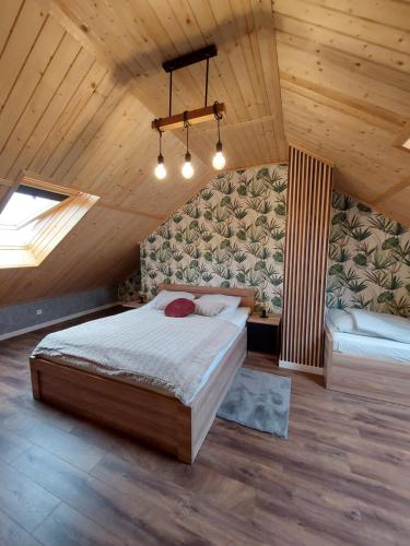 a bedroom with a bed and a couch in a attic at Willa HAFEN in Jastarnia